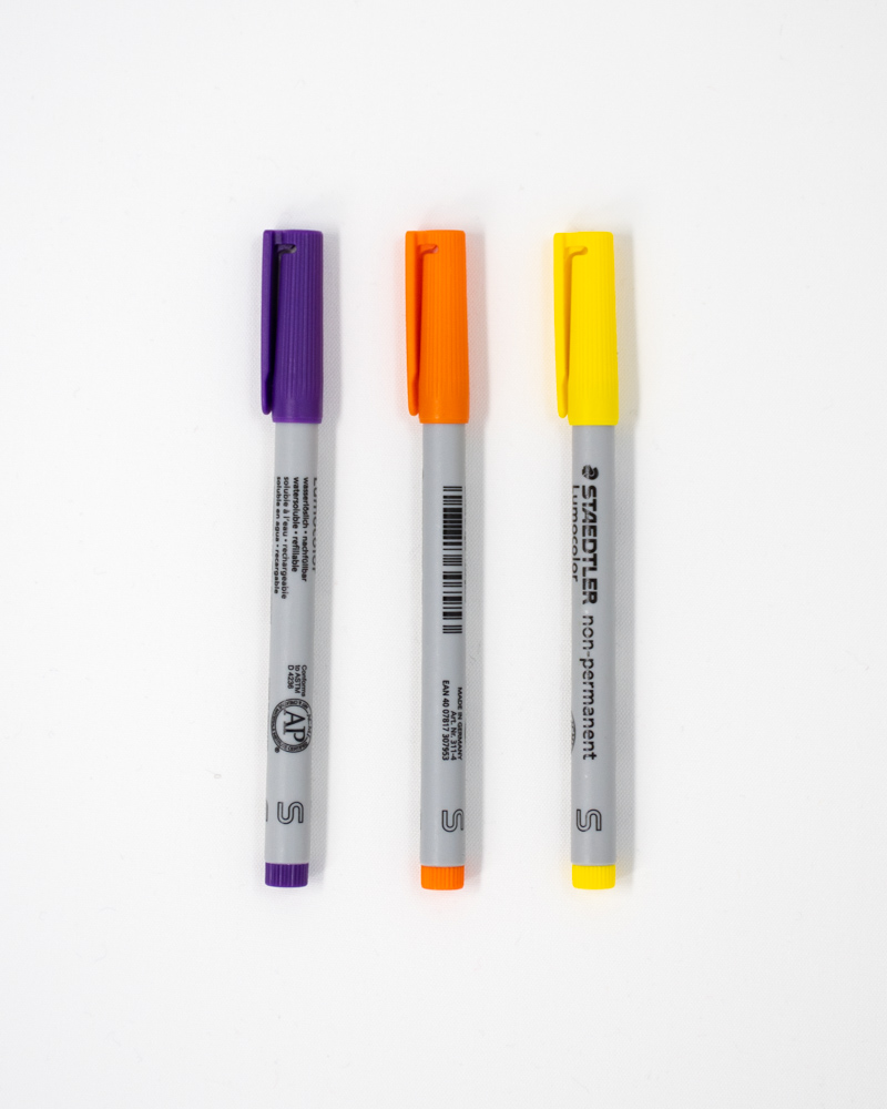 Drei Stifte in den Farben lila, orange und gelb für den Asoki Planer